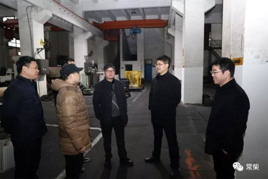 公司总经理张新（右二）在机加工厂慰问加班员工